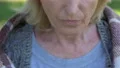 Old lonely lady eats cheap meal outdoors, indifferent relatives irresponsibility 4k or 4k+ Resolution