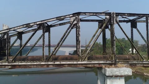 Old, long and rusty truss-type aqueduct over the river. Aerial view. 動画素材 85430548