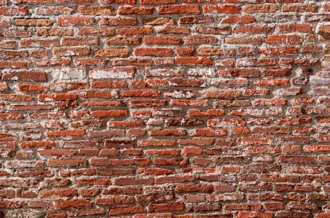 Old long narrow worn down bricks make a wall Foto stock