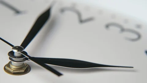 Old-looking white clock face put aslant showing twenty-five minutes past one Stock Footage 115473666