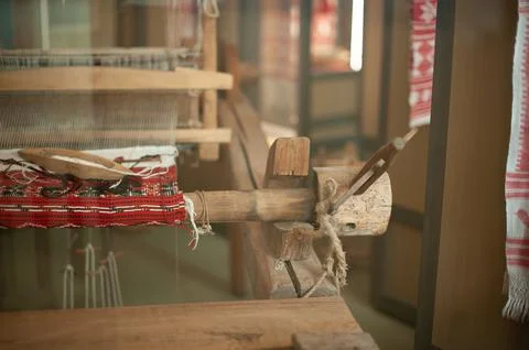 Old loom, spinning machine, rows of white and colored cotton threads Stock Photos
