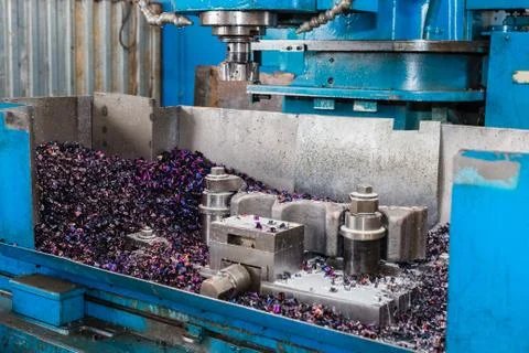 Old machine with multi-colored metal sawdust. Metalworking. Stock Photos