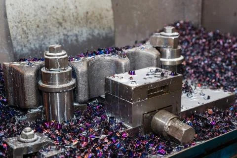 Old machine with multi-colored metal sawdust. Metalworking. Stock Photos