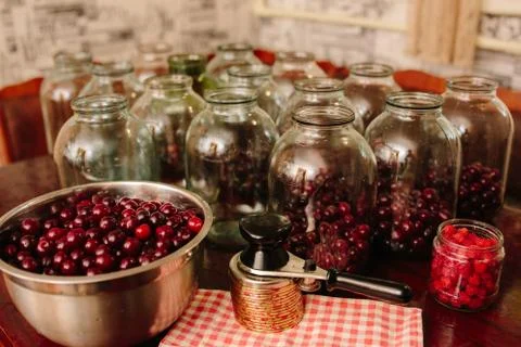 Old machine for rolling metal caps during storage. Preservation of compote fr Stock Photos
