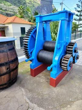 An old machine for sugar cane in a rum factory. Sugarcane juice machine. Stock Photos