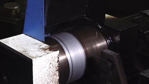 An old machine in the workshop, winds a line for cutting metal on a shaft. Stock Footage 116442662