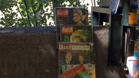 Old magazines covers at a bookstore stand in Paris selling books Stock Footage 126389888