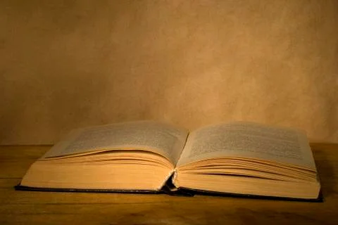 Old magic open book. Stock Photos