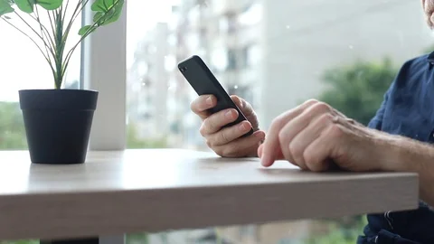 Old male hands using smartphone on table bearded adult man tapping touchscreen 스톡 동영상 110840422