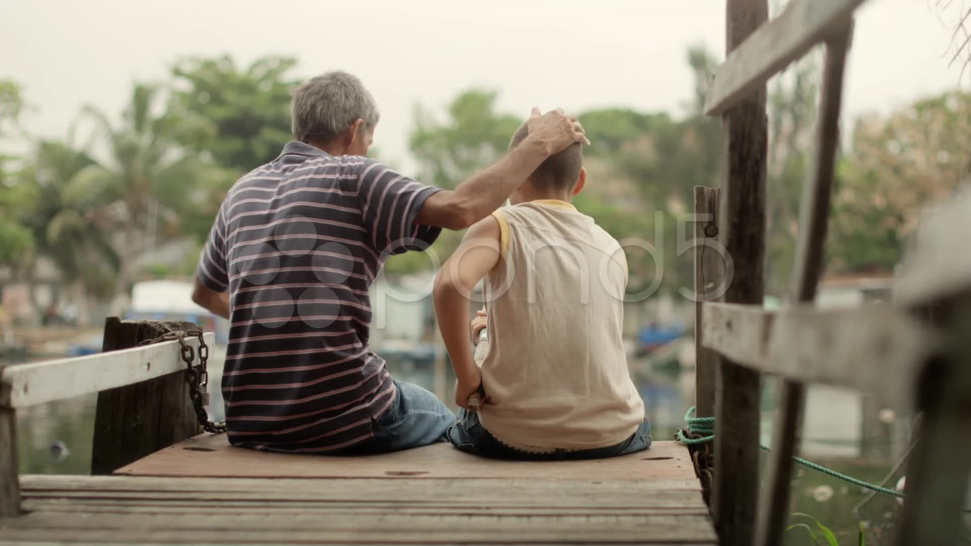 Intergenerational conversation with an old man holding a fishing