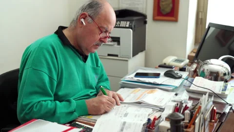 Old man and modern wireless technology. Senior man in glasses using white Stock-Footage 146208258