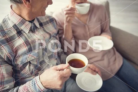 Old man and woman having pleasant pastime inside Stock Photos