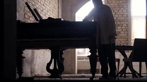 An old man of aristocratic appearance, but a bit disheveled, collects an old Stock Footage 100372947