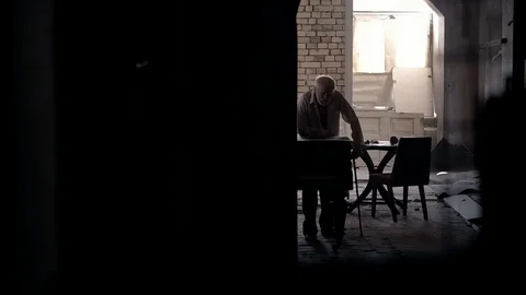 An old man of aristocratic appearance, but a bit disheveled, collects an old Video stock 100372964