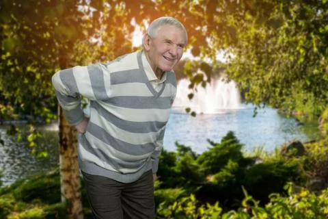 Old man with backache outdoor. Stock Photos