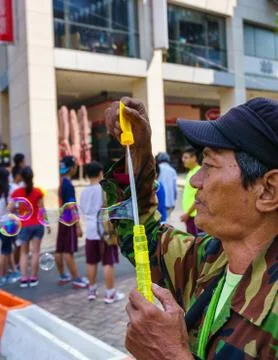 The Old man with bubble wand Stock Photos