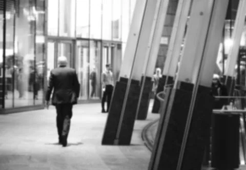 Old man business walking black and white blur Stock Photos
