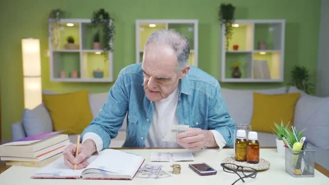 The old man calculating at home. Stock Footage 237795294