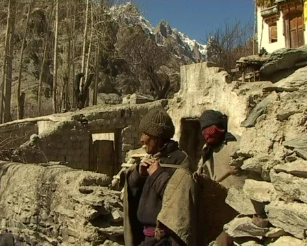 Old man carrying heavy packages in the Himalayas  Stock Footage 401088