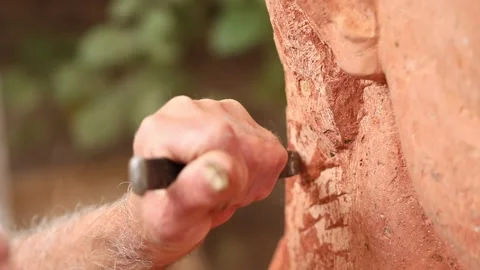 The old man carves the red stone 9 Stock-Footage 327026812
