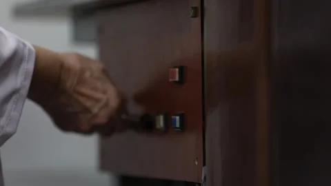 An old man checks the locks on a drawer 库存影片 314962555