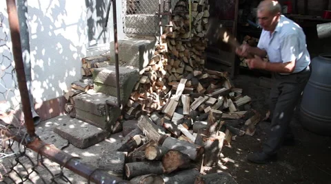 Old man chopping firewood, axe, elderly man working hard at farm Stock Footage 41266220