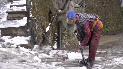 Old man cleaning snow after snowfall , Mall Road, 10 jan, 2023, Himachal Pr.. Stock Footage 231033254