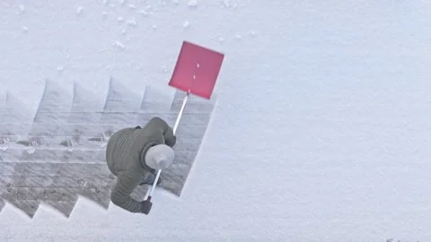 Old man cleraring snow Stock Footage 262638737