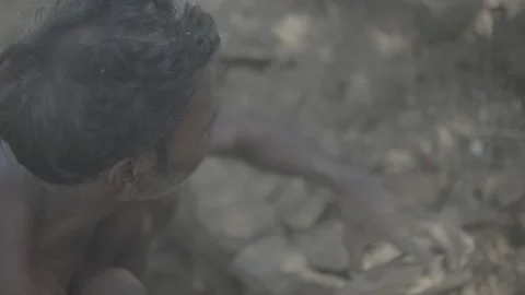 Old man collecting rocks Stock Footage 206305535