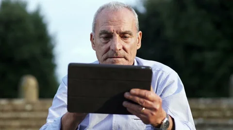Old man concentrated to use tablet Stock Footage 68548029