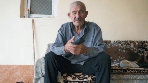 Old man on couch closeup Stock Footage 95679489