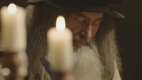 Old man counterpart of Leonardo Da Vinci working in dark room Stock-Footage 195360331