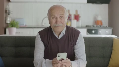 The old man dials the number on the smartphone. Stock Footage 188823596
