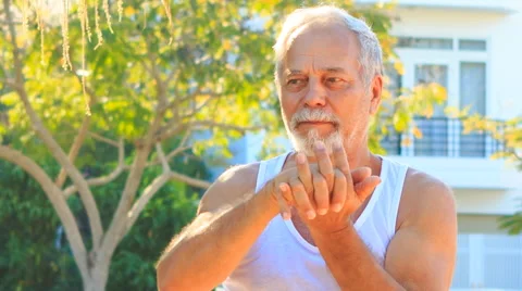Old Man Does Morning Exercises Stretches Fingers in Park Stock Footage 59587903