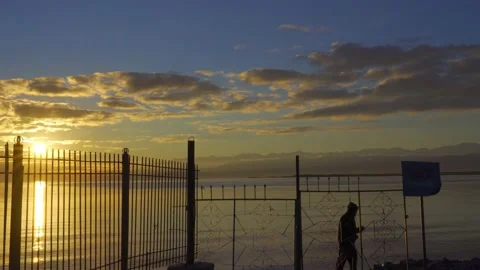 Old man is doing exercise at beautiful sunrise on the beach Stock Footage 166434421