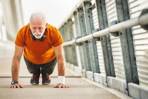 Old man doing physical exercises for a better quality of life Stock Photos