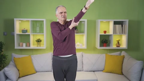 The old man doing the wrong exercise. Injury risk. 스톡 동영상 235464656