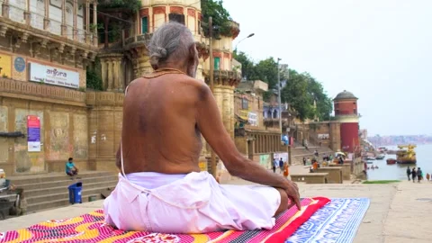Old man doing yoga in Varanasi Ghat Stock Footage 219304185