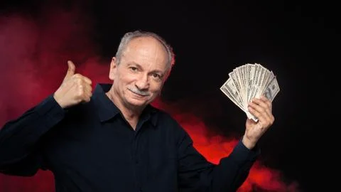 Old man with dollar bills Stock Photos