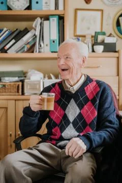 Old man drinking coffee at home Stock Photos