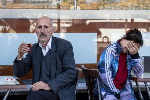 Old Man drinking tea on terrace of a cafe on the Asian side of Istanbul, Turkey Stock Photos