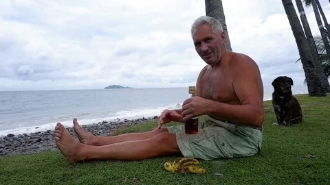 Old man drinks on the ocean. Video stock 122248083