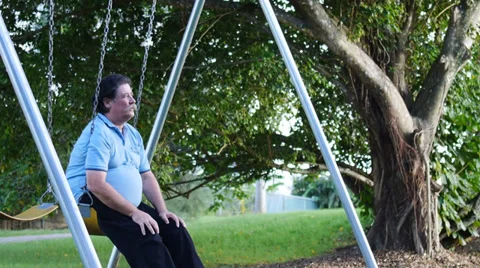 Old man elderly in playground swing 1 mov Stock Footage 31919661