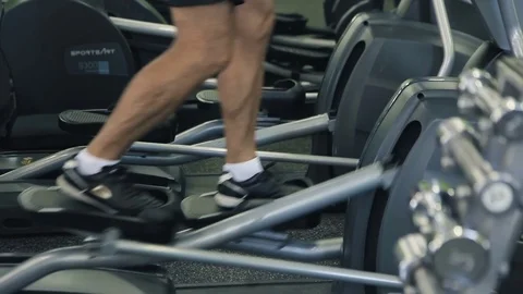 Old man is engaged on simulators in gym Video stock 71640784