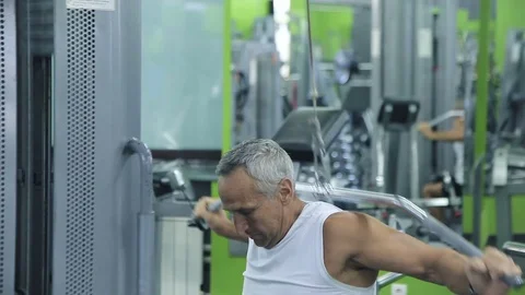 Old man is engaged on simulators in gym 스톡 동영상 71641220