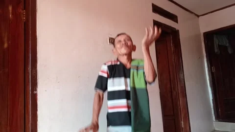 Old Man Enjoys Dancing Inside the House Stock Footage 316972569