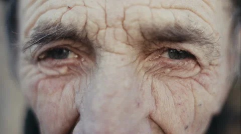 Old man face part closeup eyes looks at camera Stock Footage 58140512