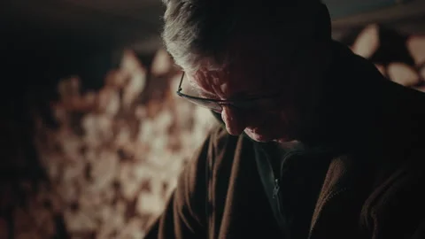 Old man face working with a saw cutting a piece of wood in his cellar 스톡 동영상 139756163