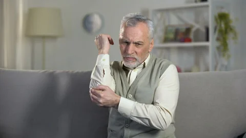 Old man feeling sharp pain in elbow, symptoms of arthritis, ligament injury Stock Footage 108152770