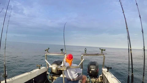 Old man fighting with a big fish off the back of angling boat Stock Footage 87792861